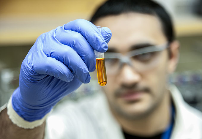Scientist holding a vial