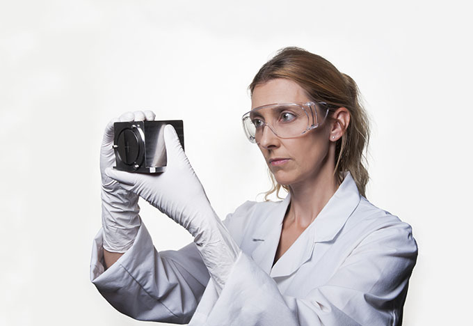 Scientist looking at metallic object